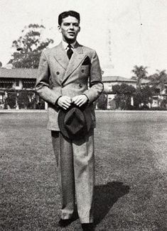 an old photo of a man in a suit and hat