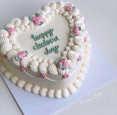 a heart shaped cake with the words happy cheesy day written in frosting