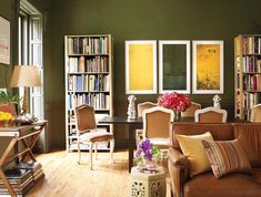 a living room filled with furniture and lots of books