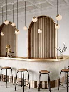 a bar with stools and lights hanging from the ceiling