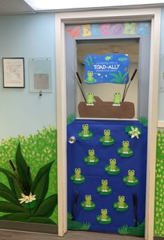 a classroom door decorated with frog images