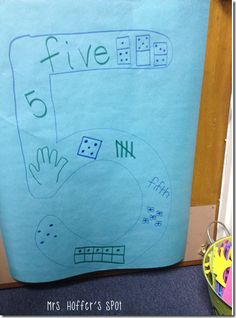 a blue paper bag with writing on it that says five five and has four dices