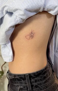 a small tattoo on the back of a woman's stomach