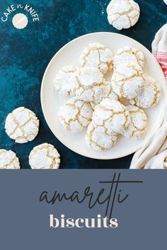 a white plate filled with powdered sugar cookies on top of a blue tablecloth