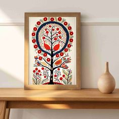 a painting is displayed on a shelf next to a vase and an apple tree with red apples