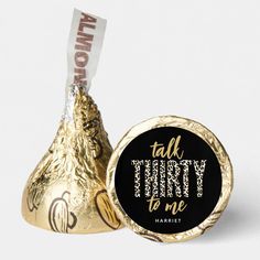 a gold foiled chocolate candy with the word graduate printed on it next to a hershey wrapper