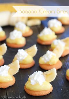 banana cream bites with whipped cream on top are sitting on a black plate and ready to be eaten