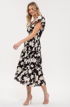 A garden of flowers bloom upon a midi dress designed in a tiered silhouette. 48 1/2" length Slips on over head Sweetheart neck Short sleeves Lined 82% rayon, 18% nylon Hand wash, dry flat Imported Chic Floral Print Tiered Dress For Garden Party, Chic Floral Print Tiered Dress For Brunch, Black Tiered Dress For Summer Vacation, Floral Print Maxi Length Tiered Dress For Brunch, Black Tiered Dress For Spring Vacation, Black Tiered Dress For Spring, Tiered Floral Print Midi Sundress, Casual Tiered Midi Dress With Floral Print, Casual Floral Print Midi Dress With Tiered Skirt