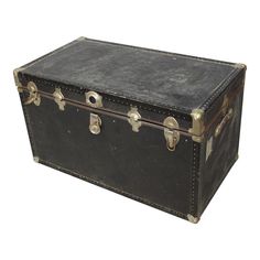 an old leather trunk is shown with brass hardware