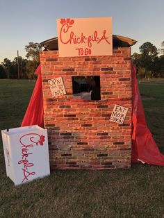 a brick building with a sign that says chickfull to go next to it