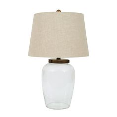 Create the exact look you want with the Woven Paths Fillable Clear Glass Table Lamp with Iron Accent and Linen Shade. Boasting a unique, customizable design, sleek silhouette, and modern flair, this accent lamp makes a brilliant complement to your room's contemporary decor. A tan linen shade completes the look and creates the perfect ambiance. Insert glass stones or marbles, change it at Christmas and insert red and green garland or Thanksgiving with decorative fall leaves. If you change the col Fillable Lamp, Clear Glass Table Lamp, Clear Glass Table, Iron Accents, Green Garland, Creative Co Op, Rustic Farmhouse Style, Accent Lamp, Home Decor Lights