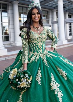 a woman in a green and gold gown with flowers on her head is posing for the camera