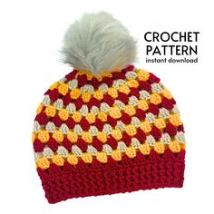 a crochet hat with a white pom - pom on the top