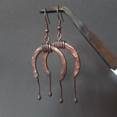 Hand-forged earrings infused with ancient symbolism. The horseshoe, a timeless emblem of luck, protection, and earth magic, is featured prominently. These pieces of jewelry evoke the spirit of a young world and the boundless freedom of the steppe. I feel it like this). Horse Shoe Earrings, Artisan Copper Dangle Hoop Earrings, Artisan Bronze Copper Hoop Earrings, Hand Forged Bronze Rustic Earrings, Artisan Hand Forged Hoop Earrings, Unique Hand Forged Brown Earrings, Hand-forged Copper Earrings In Rust Color, Rustic Bronze Earrings, Rustic Hand Forged Earrings