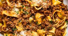 pasta with ground beef and parmesan cheese in a white bowl