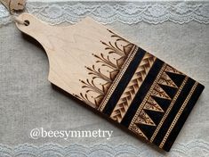 a wooden cutting board sitting on top of a white tablecloth covered table next to a pair of scissors