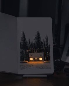 an open book sitting on top of a wooden table