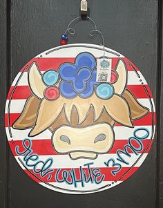 a door sign with a cow painted on it