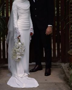 a man and woman dressed in wedding attire