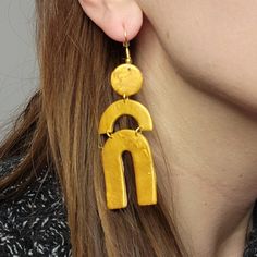 a close up of a person wearing some kind of earring with an object in the background