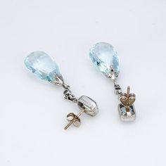 This is part of Chairish’s Fine Jewelry assortment.  Elegant pair of vintage Art Deco era aquamarine & diamond earrings (circa 1920s to 1930s) crafted in 900 platinum.   Briolette faceted aquamarines measure 18mm x 12mm (lower) and square cushion cut aquamarines measure 7mm x 5mm. Four old European cut diamonds total an estimated 0.20 carats (estimated at I-J color and SI1-2 clarity).  The opulent earrings transcend eras and are as wearable today as they were nearly 100 years ago. Meticulously c Formal Blue Topaz Diamond Earrings Fine Jewelry, Formal Blue Topaz Diamond Earrings, Formal White Gold Earrings With Blue Topaz, Light Blue Gemstone Earrings - Fine Jewelry, Fine Jewelry Light Blue Earrings For Formal Occasions, Formal Briolette Diamond Cut Earrings, Formal Light Blue Fine Jewelry Earrings, Light Blue Fine Jewelry Earrings For Formal Occasions, Classic Blue Topaz Earrings With Diamond Accents