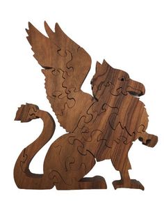 the wooden puzzle is shaped like a dragon