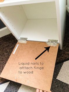 a cardboard box with an arrow sticking out of it's bottom that says liquid nails to attach hinge to wood