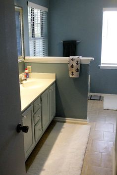 a bathroom with blue walls and white fixtures