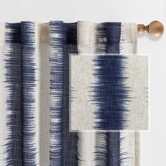 the curtain is made from blue and white fabric with an abstract design on it's side