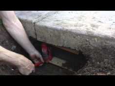 a man is working on a hole in the ground