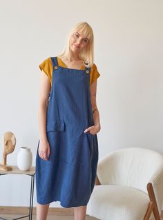 Made from prewashed and soft linen, this navy overall comes in dialogue with many different tops. Feel stylish in a natural way! Details: - 100% Linen - Pure linen fabric - Adjustable straps - Two front flap pockets - Side buttons closure - Below-knee length - Comfortable relaxed fit - Model's height is 178 cm / 5'10'' wears size M - Code: E9047-L532-152 The overall is available in other colors. You can find them in the gallery. If you want to order the overall in another color, please specify i Blue Cotton Pinafore Dress With Pockets, Summer Bib Front Dress With Pockets, Casual Dresses With Bib Front And Pockets, Casual Bib Front Dress With Pockets, Blue Linen Dress With Pockets, Sleeveless Linen Overalls, Sleeveless Linen Overalls With Pockets, Sleeveless Linen Pinafore Dress With Pockets, Womens Overalls