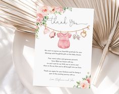 a thank card for a baby shower with pink flowers and clothes hanging from a line