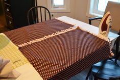 a kitchen table with a ironing board on it