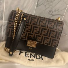 This Is An Authentic Fendi Vitello Liberty Bi-Color Ff 1974 Embossed Chain Strap Kan U Shoulder Bag In Black And Maya. This Bag Is Crafted Of Smooth Calfskin Leather In Black, With A Black On Brown Ff Logo-Embossed Flap. The Bag Features A Leather Top Handle And An Optional Shoulder Strap With Gold Hardware. The Flap Opens With A Fendi Ff Logo Press Lock To A Partitioned Beige Suede Interior With A Patch Pocket. Box And Sealed Fendi Authentic Letter & Tag And Bag; Used Once - Basically Brand New Ff Logo, Cell Phone Holster, Phone Holster, Walker Boots, Fit N Flare Dress, Rain And Snow Boots, Boot Sandals, Leather Top, Chain Strap