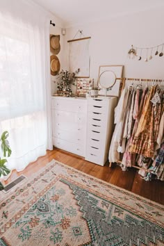 a room filled with lots of clothes and rugs