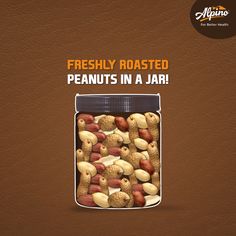 a jar filled with peanuts and nuts sitting on top of a table