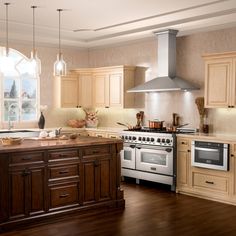 a kitchen with an oven, stove and sink in it's center island next to a window