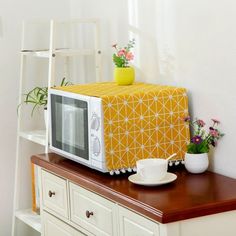 a microwave sitting on top of a wooden table