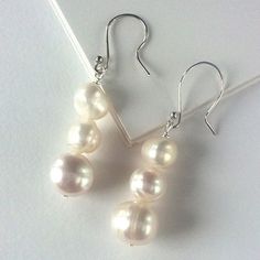 Triple White Pearl Dangle Earrings Classic Hypoallergenic Earrings For Party, Elegant Hypoallergenic Party Earrings, Elegant Hypoallergenic Earrings For Party, Classic Party Earrings With Ear Wire, White Linear Earrings With Ear Wire For Anniversary, Elegant Hypoallergenic Pearl Earrings For Party, White Linear Earrings For Anniversary, Pearl White Earrings With Ear Wire For Party, Pearl White Party Earrings With Hooks