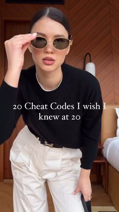 a woman wearing white pants and black sweater with the words 20 cheap code i wish knew at 20