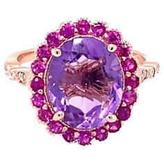 3.79 Carat Natural Amethyst Pink Sapphire Diamond Rose Gold Engagement Ring Playful yet Powerful! Its like having a piece of glittery candy on your finger! This ring has a bright Oval Cut Amethyst that weighs 3.10 Carats and is embellished with a halo of 20 Pink Sapphires that weigh 0.57 Carats as well as 12 Round Cut Diamonds along the shank that weigh 0.12 Carats. The total carat weight of the ring is 3.79 Carats. The ring is crafted in 14 Karat Rose Gold and weighs approximately 3.9 grams. The ring is a size 7 and can be re-sized at no additional charge. Rose Gold Diamond Ring Engagement, Pink Sapphire Ring, Purple Jewelry, Gold Cocktail Ring, Gold Cocktail, All Things Purple, Rose Gold Engagement, Put A Ring On It, Gold Engagement Ring