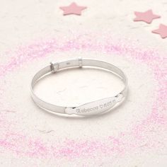 PRODUCT DESCRIPTION * A classic sterling silver expanding baby bangle with a personalised ID plate. * The perfect gift for christenings, birthdays and other special occasions. PERSONALISATION * See image for font options. * We engrave our pieces to create bespoke items especially for you, we are always happy to try and help if something is unsuitable but we regret we are unable to offer refunds on personalised items. FREE GIFT BOX * This bracelet comes beautifully packaged in our Hurleyburley gi Classic Silver Name Bracelet For Birthday, Silver Round Name Bracelet For Birthday, Personalized Silver Name Bracelet For Baptism, Classic Adjustable Name Bracelet For Birthday, Silver Bracelets With Engraving Option For Birthday, Adjustable Silver Name Bracelet For Baptism, Custom Name Silver Jewelry For Baptism, Unique Bangle, Baby Bangles