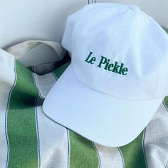 The perfect hat for Pickle Lovers and Pickle Ball champs. * 100% chino cotton twill * Green Camo color is 35% chino cotton twill, 65% polyester * Unstructured, 6-panel, low-profile * 6 embroidered eyelets * 3 ⅛" (7.6 cm) crown * Adjustable strap with antique buckle * Blank product sourced from Vietnam or Bangladesh This product is made especially for you as soon as you place an order, which is why it takes us a bit longer to deliver it to you. Making products on demand instead of in bulk helps reduce overproduction, so thank you for making thoughtful purchasing decisions! 5-panel Cotton Hat With Embroidered Logo, White Cotton 5-panel Dad Hat, White 5-panel Cotton Dad Hat, Cotton Trucker Hat With Letter Print And Short Brim, Cotton Dad Hat With Embroidered Logo And Short Brim, Adjustable Cotton Hats With Letter Embroidery, Cotton Dad Hat With Letter Print And Short Brim, White Embroidered Cotton Dad Hat, White Cotton Dad Hat With Letter Embroidery