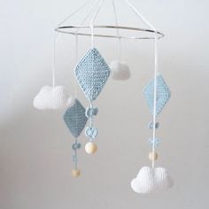 a crocheted mobile with hearts hanging from it