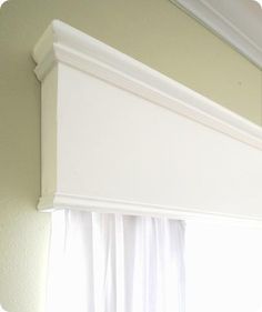 an open window with white drapes on the top and bottom part of the curtain