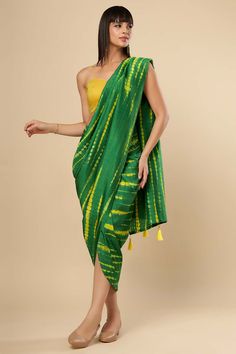 Crafted in Dola Silk this Wrap around Sarong Saree with an attached drape is a versatile piece thats an adaptable as it is stylish, designed for the woman who commands her look with the confidence. The blouse is optional and sold separately. Watch the video to see how easy it is! The blouse is optional and sold separately. Watch the video to see how easy it is! About this Product Sarong Saree: Saree Type: Ready to wear, Wrap around Sarong Saree Color: Green & Yellow Saree Fabric: Silk Work: Tye Traditional Green Draped Blouse Piece, Traditional Green Draped Dupatta, Bohemian Blouse Piece With Traditional Drape, Green Pre-draped Saree With Traditional Drape, Cotton Silk Pre-draped Saree For Diwali, Diwali Cotton Silk Pre-draped Saree, Silk Draped Dupatta, Bohemian Designer Blouse Piece For Summer, Traditional Green Draped Saree