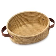 a woven basket with leather handles on a white background