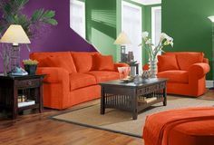 a living room filled with orange and green furniture