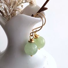 "6662 Green Jade Earrings natural stone dangle drops simple modern everyday casual boho chic gold plate birthday anniversary Valentine's day Mother's day Christmas stuffing stockings holiday gift for her women mom sister wife girlfriend daughter niece aunt grandma cousin colleague best friend. Enjoy the beauty & power of natural gemstones. MATERIALS & DIMENSIONS ✦ Natural JADE, light green, smooth round beads 10mm; ✦ GOLD Plated pins, spacers and handmade fish hook ear wires; ✦ The total length Trendy Gold Jewelry With Natural Stones, Modern Gold Earrings For May Birthstone, Gold Hypoallergenic Jade Earrings, Minimalist Gemstone Earrings For May Birthstone, Hypoallergenic Gold Jade Earrings, Elegant Green Earrings For Mother's Day, Elegant Everyday Jade Jewelry, Minimalist Earrings For Everyday And Mother's Day, Everyday Gold Gemstone Earrings