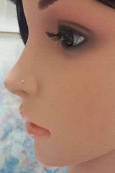 a mannequin's head with fake eyelashes and eyeliners